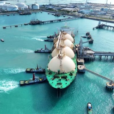 LNG (Liquefied natural gas) tanker anchored in Gas terminal gas tanks for storage. Oil Crude Gas Tanker Ship. LPG at Tanker Bay Petroleum Chemical or Methane freighter export import transportation